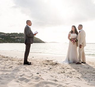 Island Mike officiates a wedding ceremony on the beach in St. Thomas