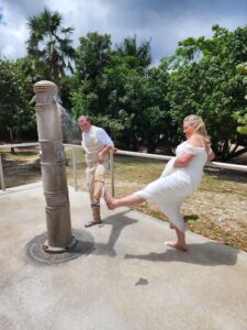 bride and groom washing the sand off their feet