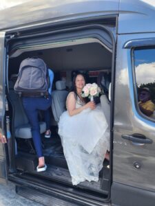 bride in a taxi arriving at the beach