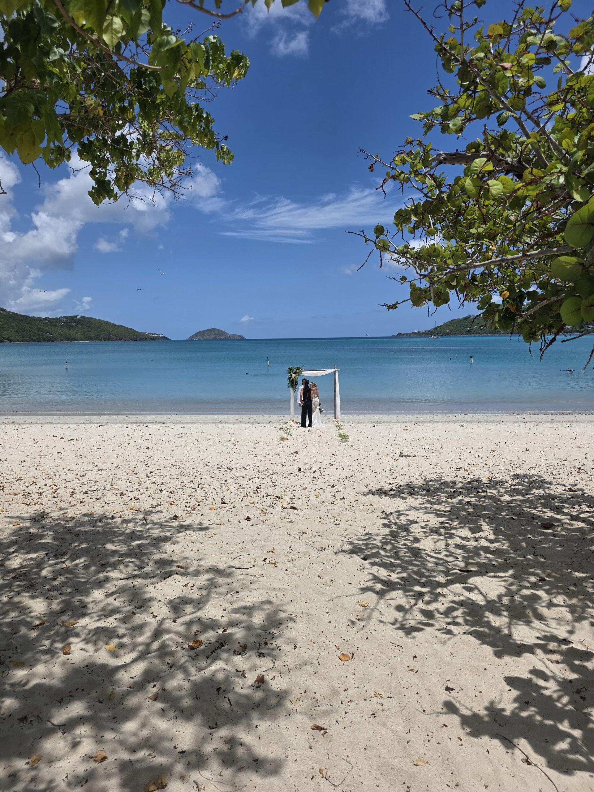 Bride and groom ceremony at Magens Bay Beach St. Thomas USVI — calm turquoise water and white sand
